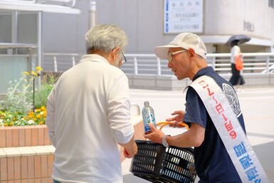 母子に備蓄水を手渡す吉田管理者